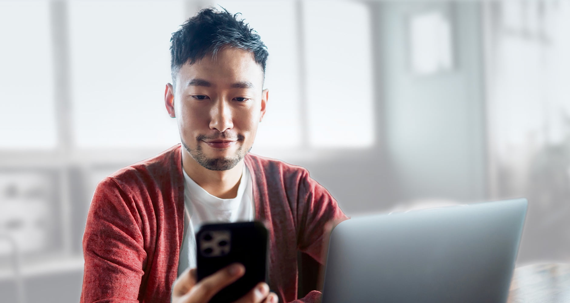 Man using a phone to trade online with OCBC Securities